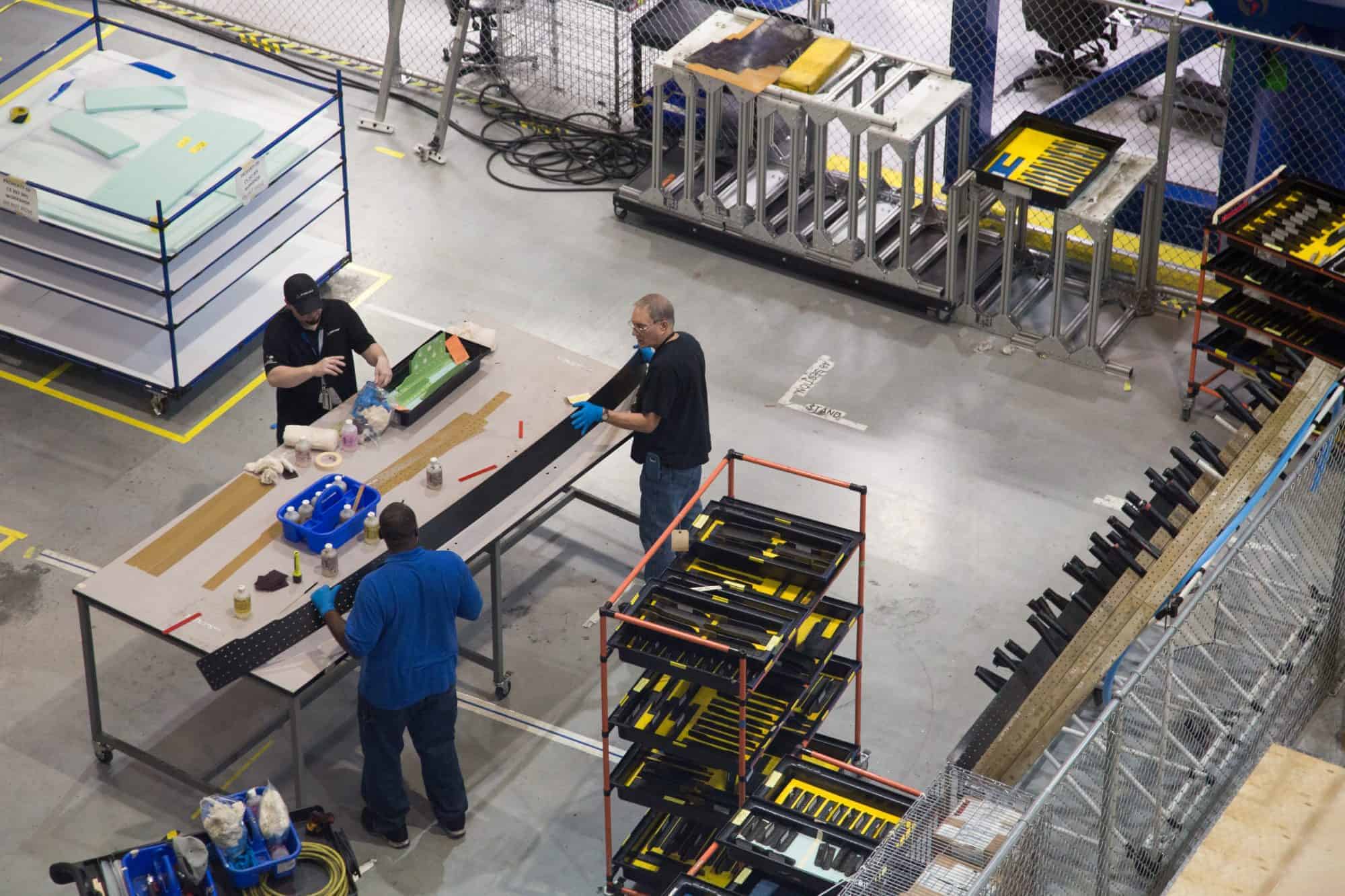 Manufacturing workers make products on a shopfloor.