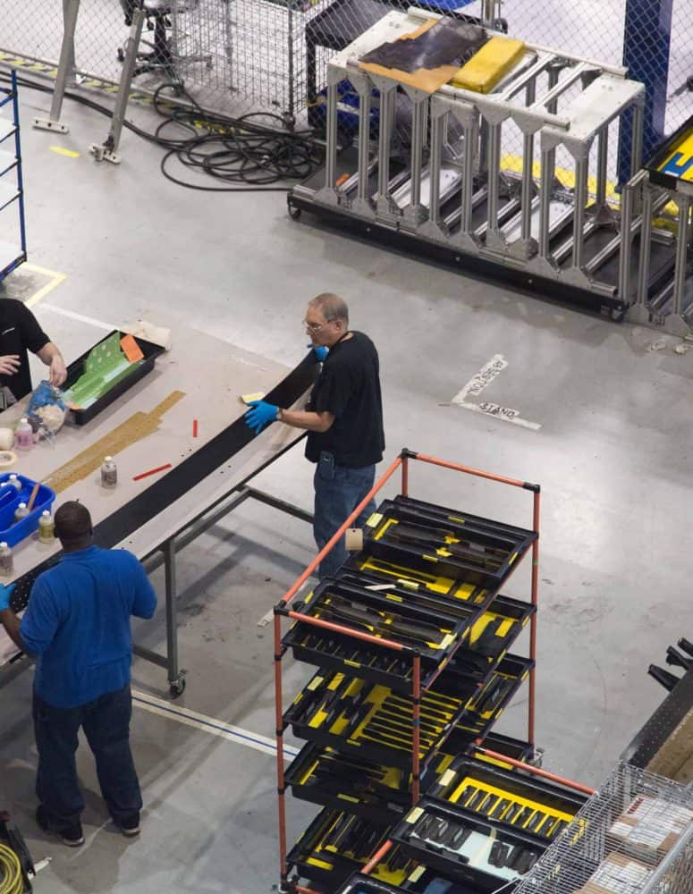 Manufacturing workers make products on a shopfloor.