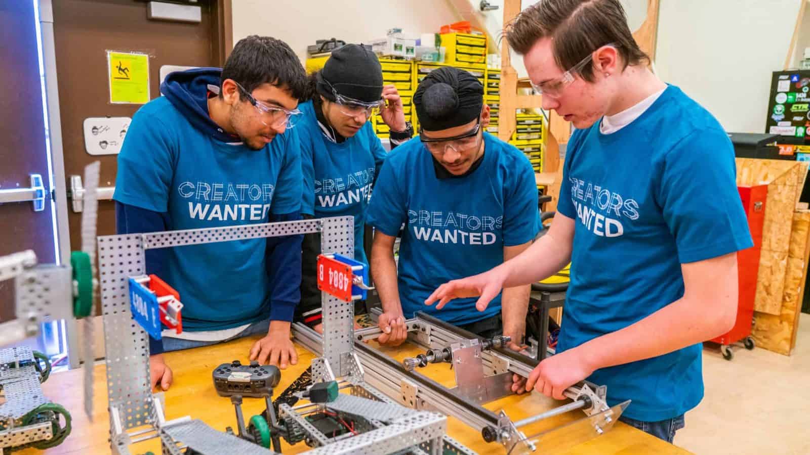 Students work on a manufacturing project while wearing Creators Wanted t-shirts