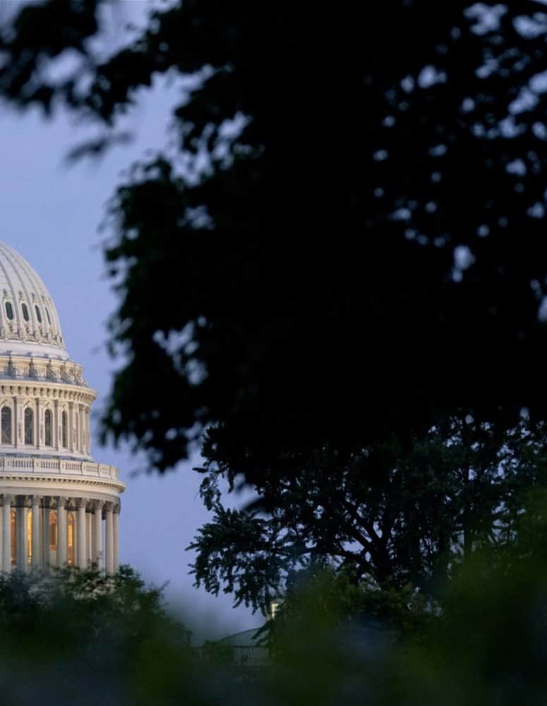 a large building in the background with United States Capitol in the background