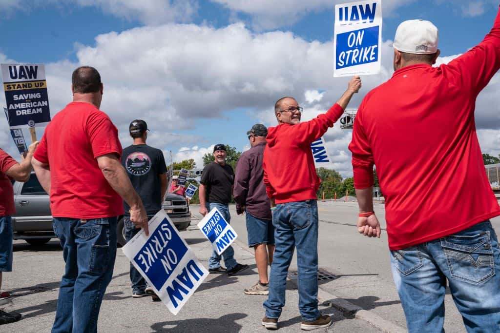 a group of people holding a sign