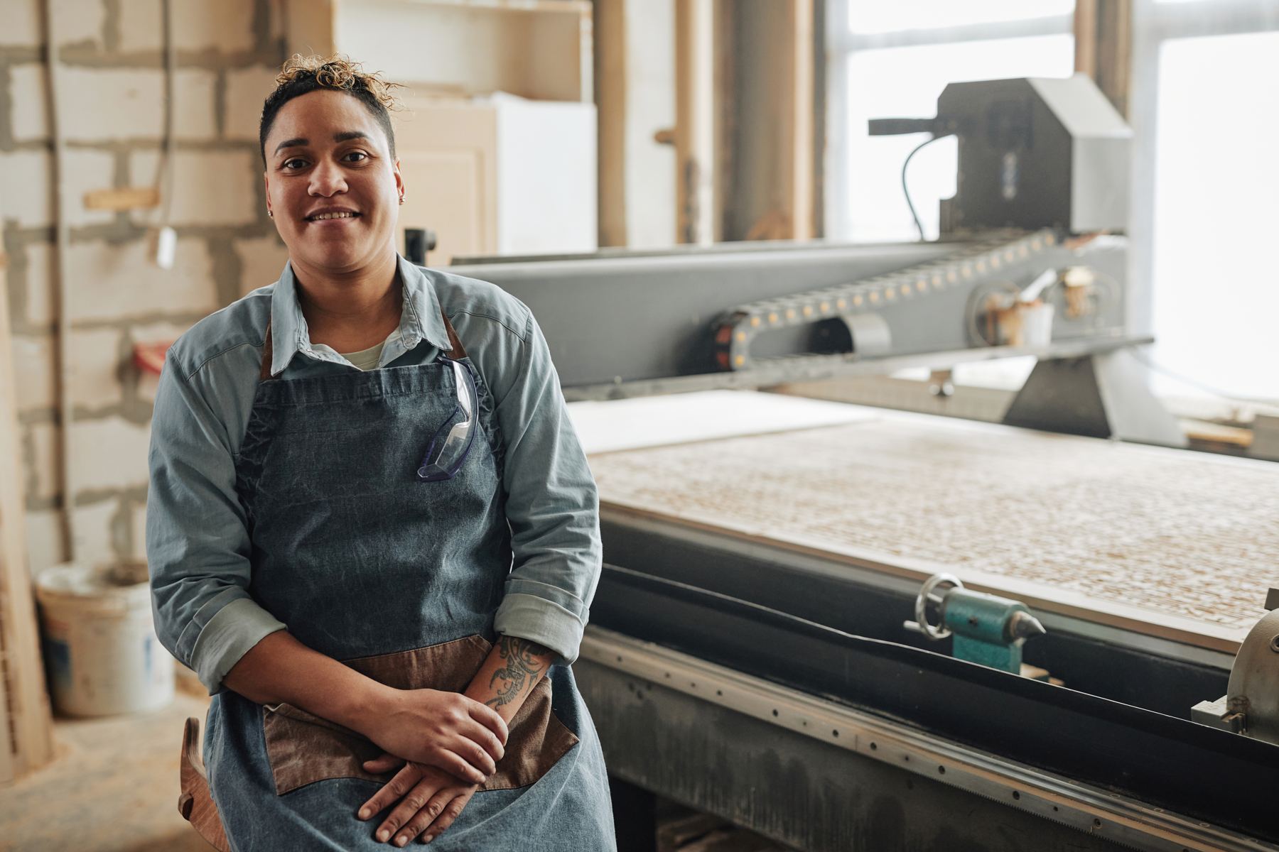Small manufacturing business owner at a CNC machine in her workshop