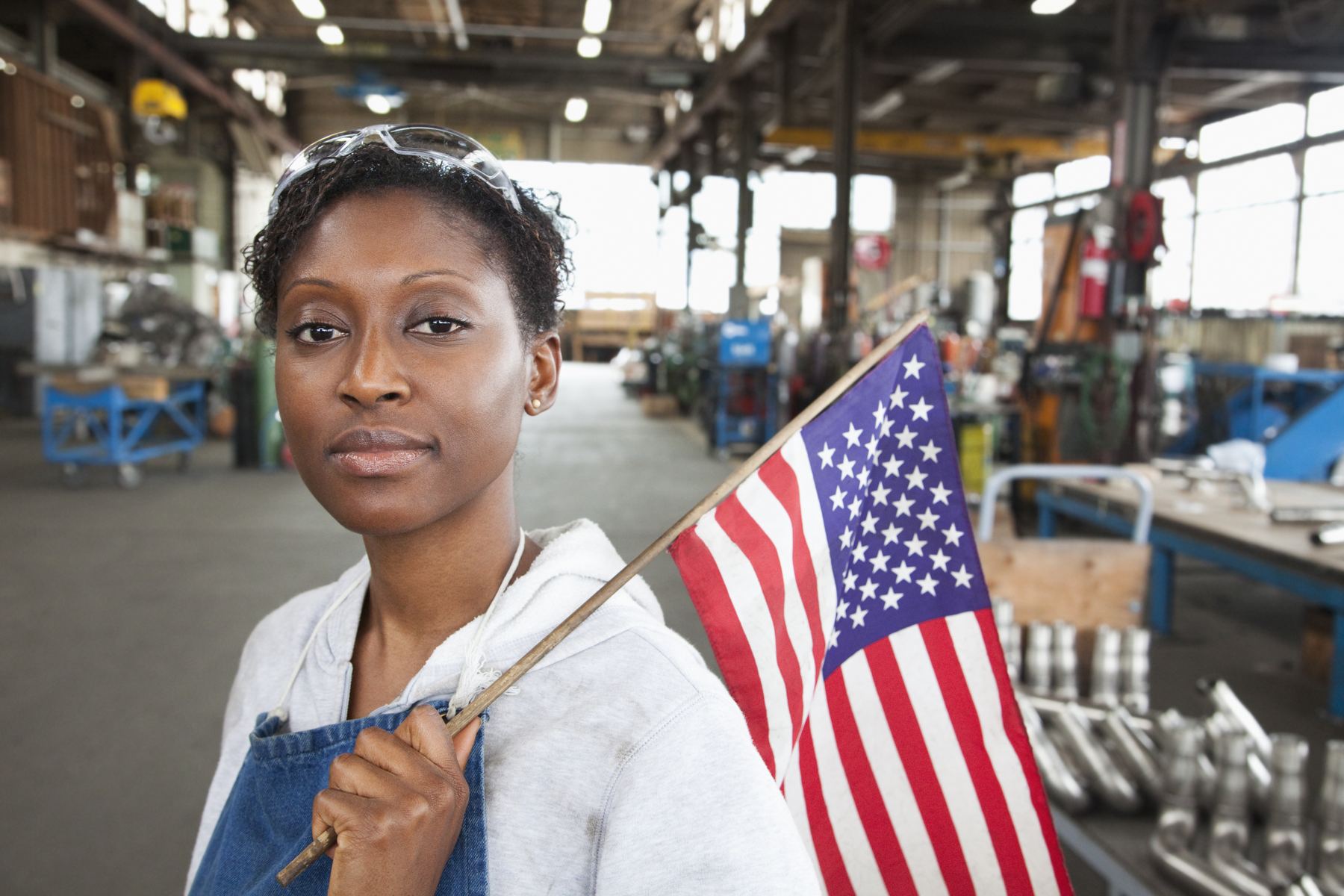 Manufacturing worker with an American flag