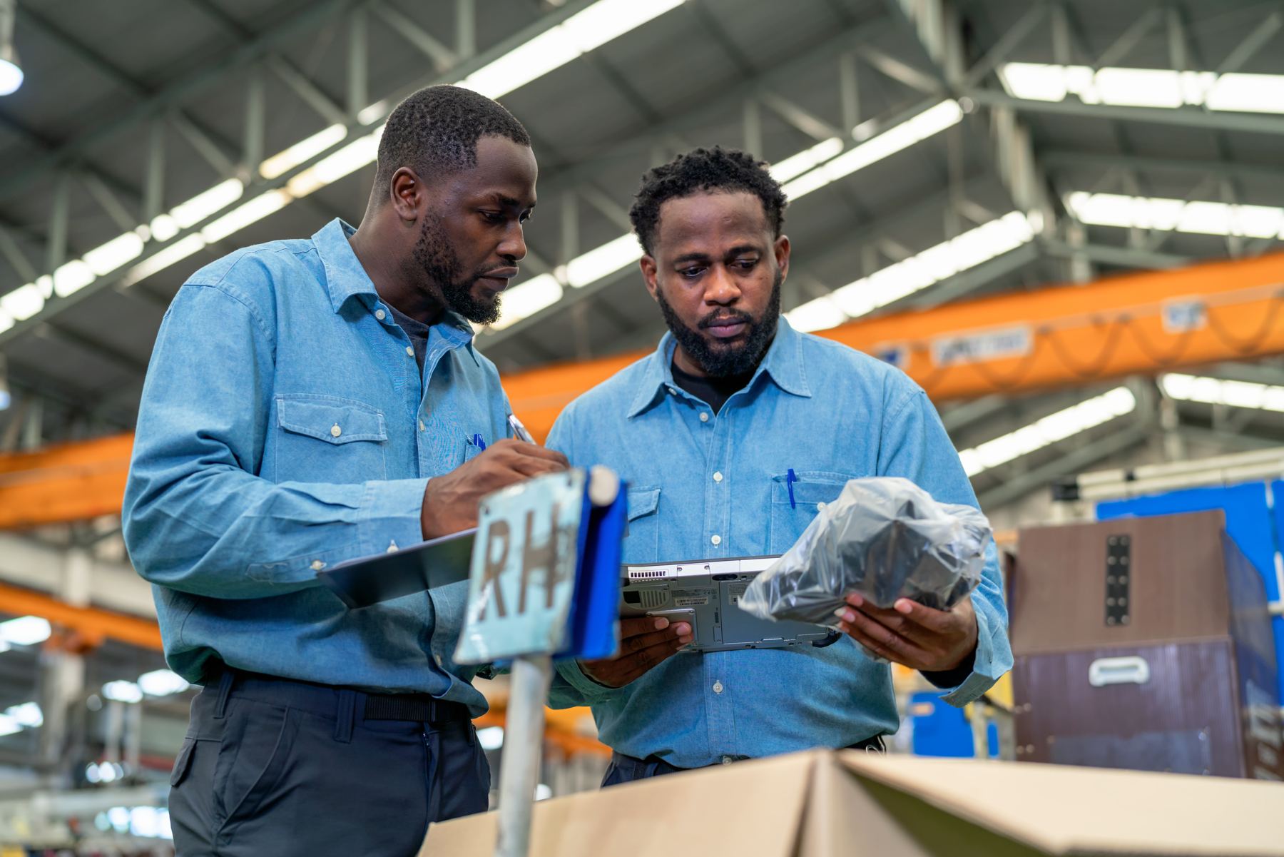 Manufacturer reviewing data on a tablet on the shop floor